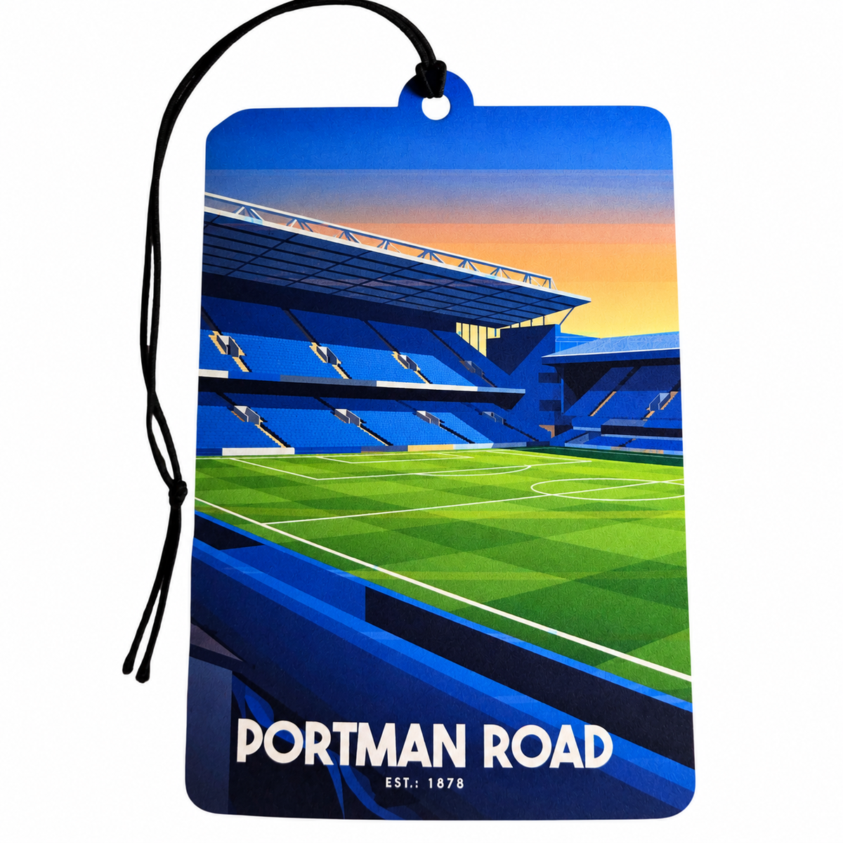 Ipswich Town inspired car air freshener featuring Portman Road football stadium, blue stands, green pitch, sunset sky, Est. 1878 lettering and black hanging cord.