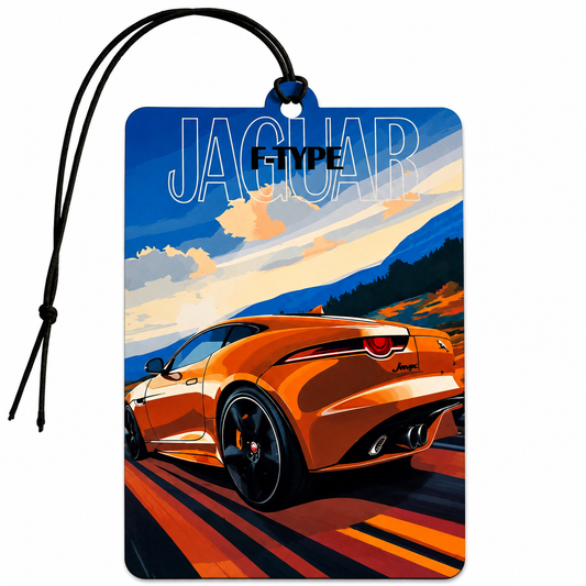 A rectangular car air freshener tag featuring a stylized illustration of an orange Jaguar F-Type sports car on a scenic road with mountains and a blue sky. The word 'JAGUAR' is printed at the top, and a black hanging loop with a black cord is attached at the top center.