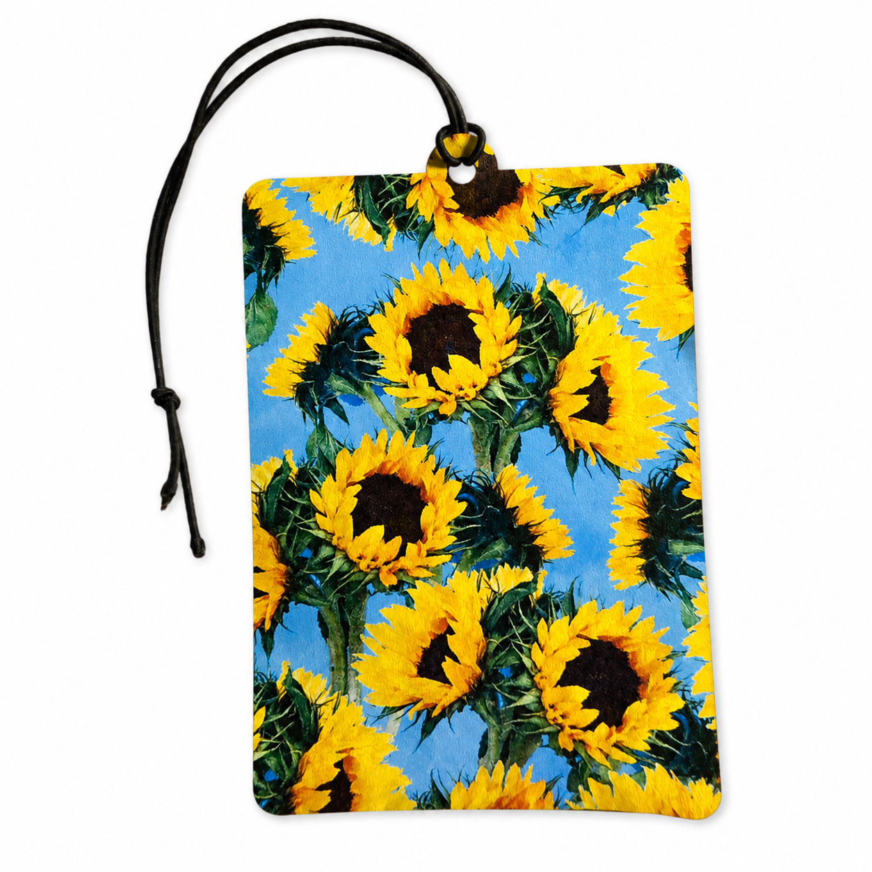 A rectangular car air freshener or tag with a black hanging cord, featuring a vibrant sunflower pattern on a light blue background.