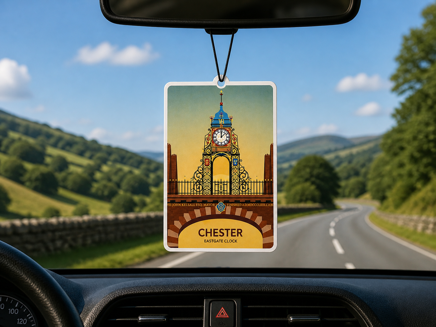 Car air freshener with Chester eastgate clock design hanging from a car's rearview mirror.