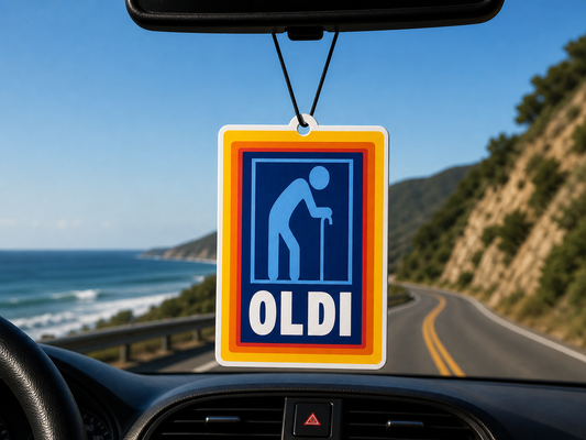 Car air freshener with 'OLDI' branding hanging from a car's rearview mirror with a scenic road and ocean view.