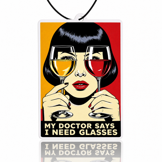 Car air freshener with a graphic of a woman holding two wine glasses and text 'My doctor says I need glasses'.
