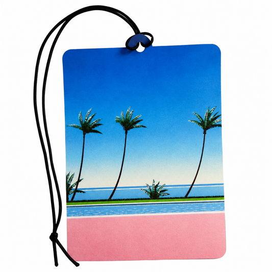 A rectangular car air freshener or luggage tag with a black hanging cord, featuring a tropical beach scene with palm trees, blue sky, ocean, and a pink lower section, shown on a white background.