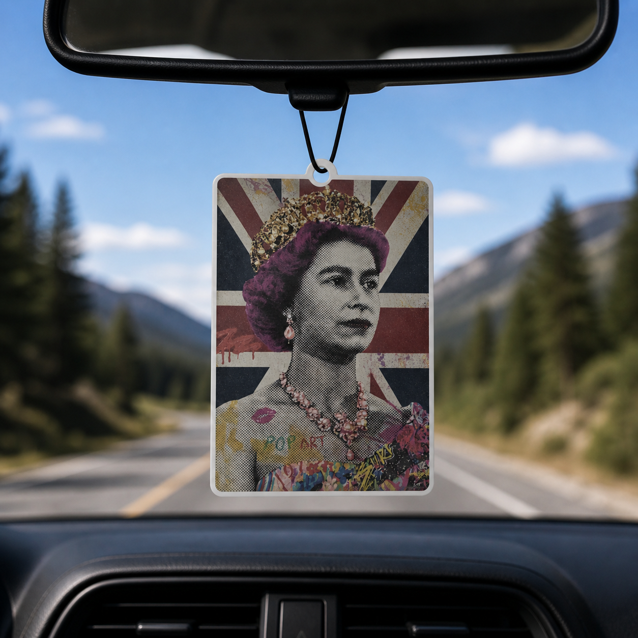 Car air freshener with a portrait of a monarch on a road with mountains in the background