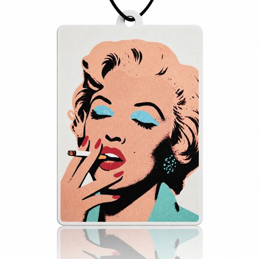 Stylized portrait car air freshener of a famous actress on a rectangular white card with a black border.