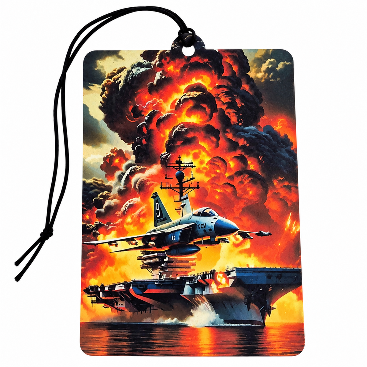 A rectangular car air freshener or luggage tag with a black hanging cord, featuring a dramatic military illustration of an aircraft carrier and fighter jet in front of a massive fiery explosion on a white background.
