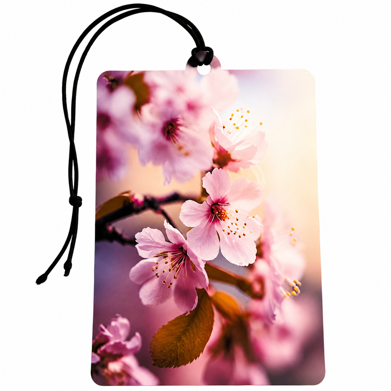 A rectangular hanging tag or car air freshener with rounded corners, printed with a close-up floral design of pink blossoms and brown leaves on a soft blurred background. A black cord is attached at the top, and the card is photographed on a plain white background.