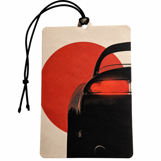 A rectangular hanging tag or car air freshener with a black cord loop at the top, featuring a minimalist graphic of a red sun and part of a black car on a light beige background.